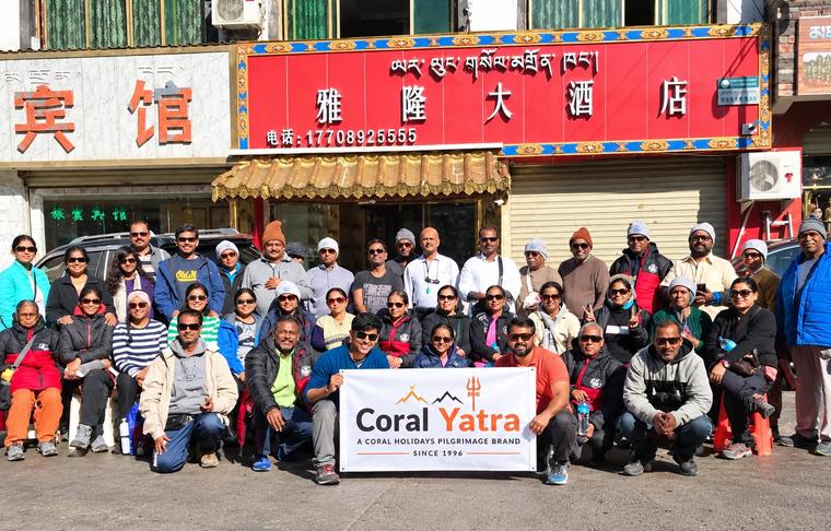 A Coral Yatra pilgrim group holding the Coral Yatra banner